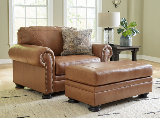 Signature Design by Ashley Carianna living room set with stationary chair and ottoman in a cozy, stylish home setting.