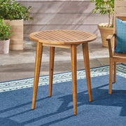 Noble House Stamford outdoor bistro table with water-resistant teak finish, ideal for patios and outdoor dining spaces.