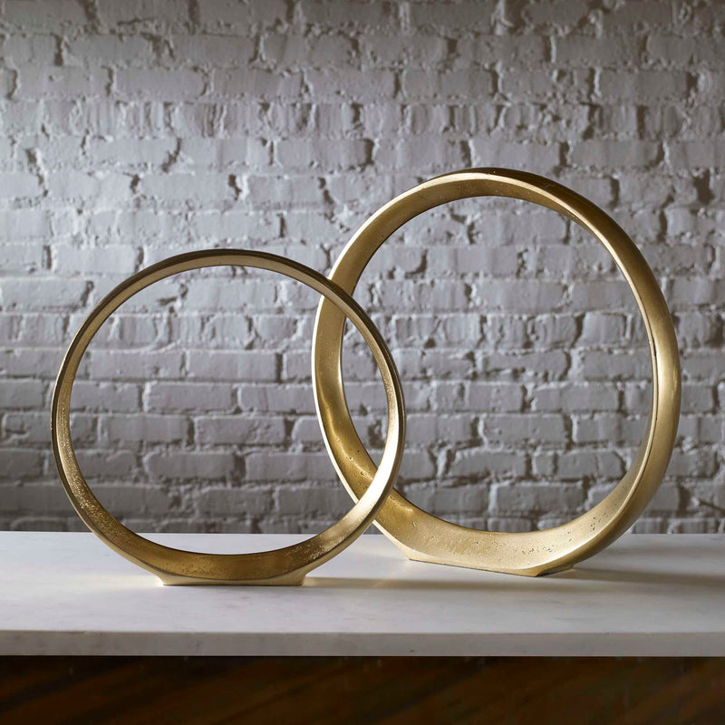 Pair of gold Jimena ring sculptures by Uttermost, decorative sculptures and figurines with modern elegance.