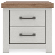Benchcraft Savonport two-drawer nightstand with charging station in white and brown, featuring a modern design and functional storage.