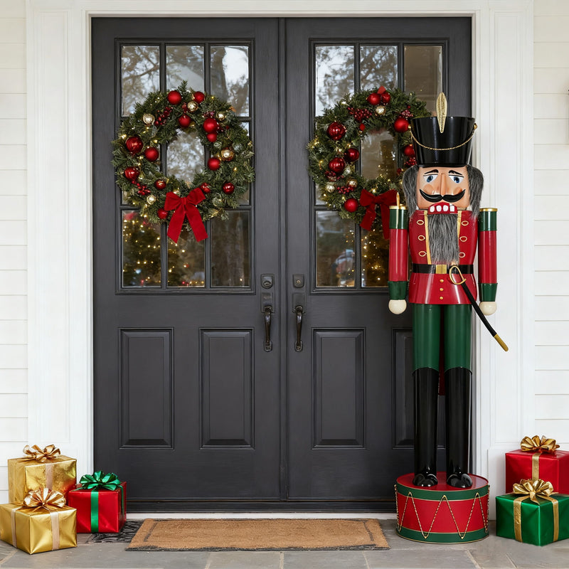 Noble House classic Christmas nutcracker holiday decor in green and red standing on a festive background