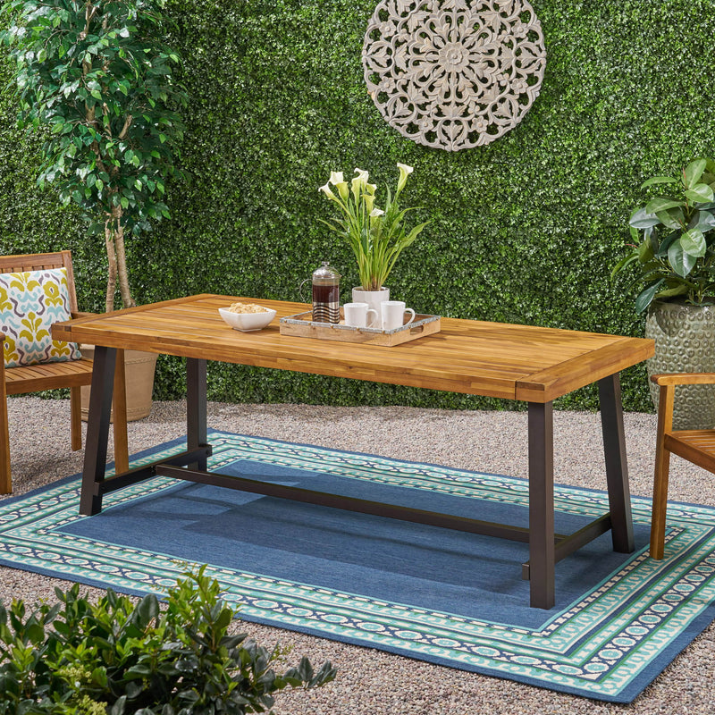 Noble House Equilibrium outdoor dining table with wooden frame and slat top, perfect for patio or garden dining spaces.