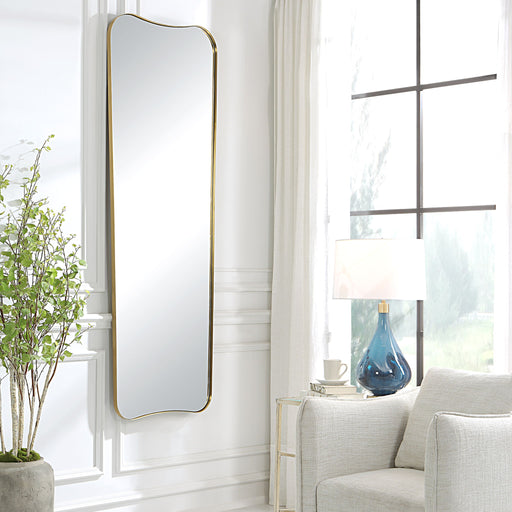 Large wall mirror by Uttermost in antique brass finish, featuring a sleek, modern design with a rectangular frame.