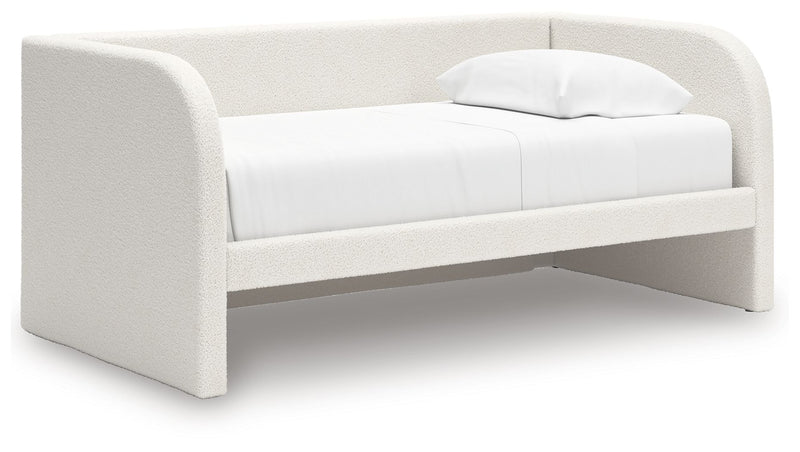 Upholstered Signature Design by Ashley Arloster day bed with plush fabric, wooden frame, and cushioned backrest, ideal for lounging.