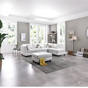 Glory Furniture Malone Comfort Sectional sofa with plush cushions and neutral fabric upholstery in a spacious living room setting.