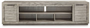 Naydell - XL TV Stand w/Fireplace Option - Gray - R&R Furniture Gallery (Fountain Valley, CA)