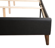 Contemporary upholstered bed by Glory Furniture in a spacious bedroom, featuring a sleek design and plush fabric for modern comfort.