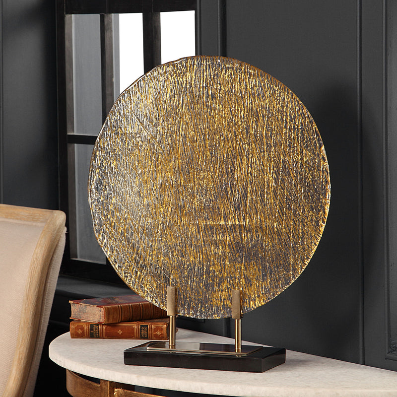 Uttermost Layan Art Glass Charger sculpture with a gold finish, featuring a sleek, artistic design perfect for decorative display.