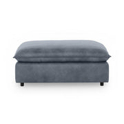 Classic Home Caplan upholstered ottoman with cushioned top and wooden legs, versatile accent piece for living rooms.