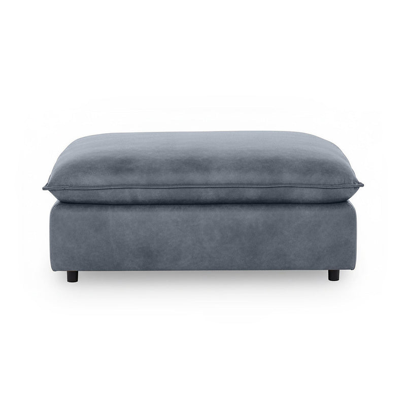 Classic Home Caplan upholstered ottoman with cushioned top and wooden legs, versatile accent piece for living rooms.