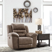 Signature Design by Ashley Stoneland power recliner rocker chair with plush cushioning and modern design, shown in a cozy living room setting.