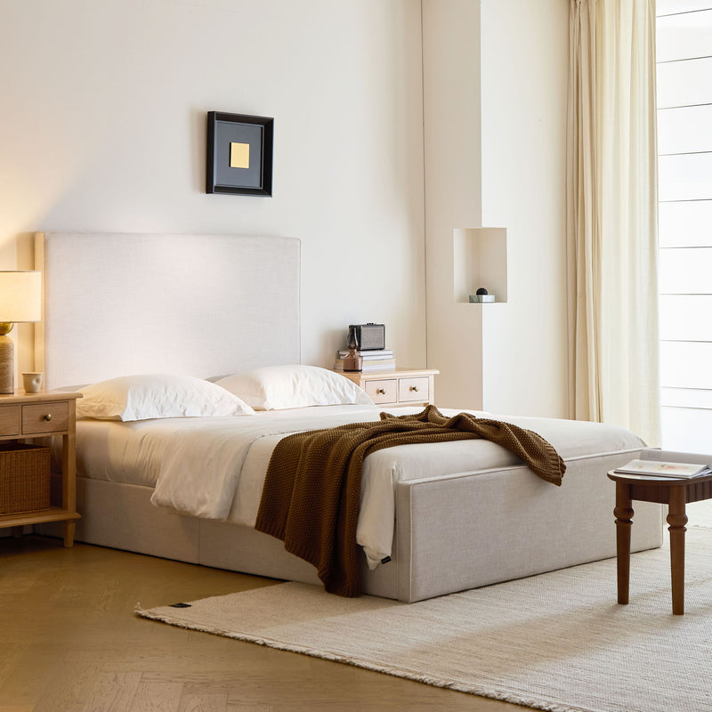 House & Home Furniture Lucas tall upholstered bed headboard with soft fabric and modern design, shown in a stylish bedroom setting.