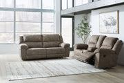 Signature Design by Ashley Laresview reclining sofa and loveseat set in a modern living room scene.