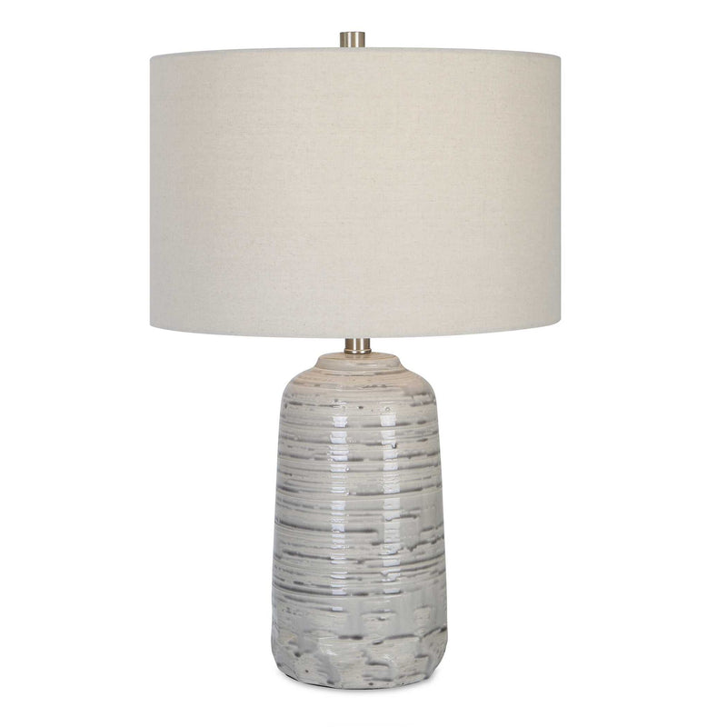 Uttermost Cyclone ivory table lamp with a textured, sculptural base and fabric shade, perfect for modern living room decor.