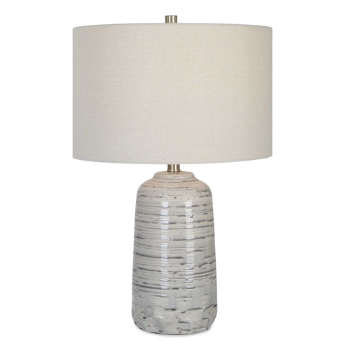 Uttermost Cyclone ivory table lamp with a textured, sculptural base and fabric shade, perfect for modern living room decor.
