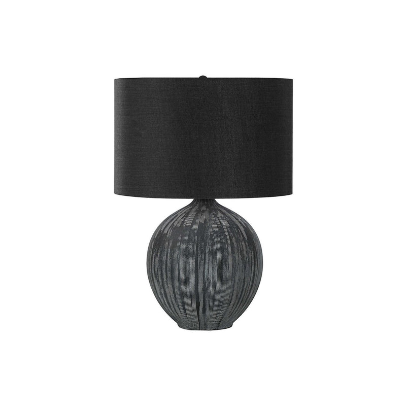 Contemporary black ceramic table lamp by 8th Street with a sleek, modern design and a smooth, rounded base.