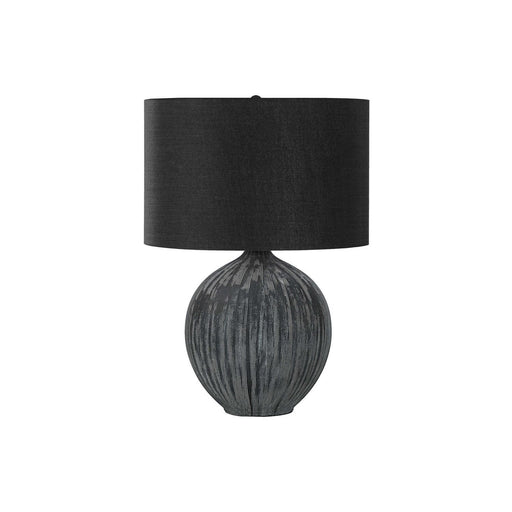 Contemporary black ceramic table lamp by 8th Street with a sleek, modern design and a smooth, rounded base.