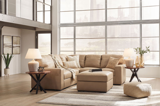 Signature Design by Ashley Bandon 3-piece living room set with sofa, loveseat, and armchair in a modern living space.