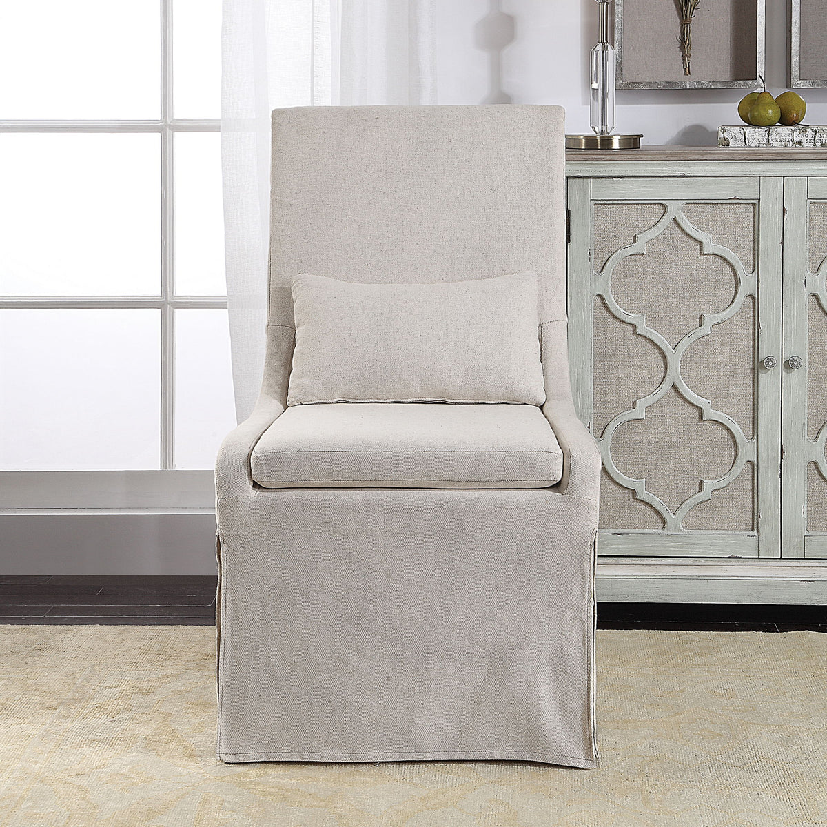 Uttermost Coley armless side chair with elegant fabric upholstery and wooden legs, modern design for dining or living space.