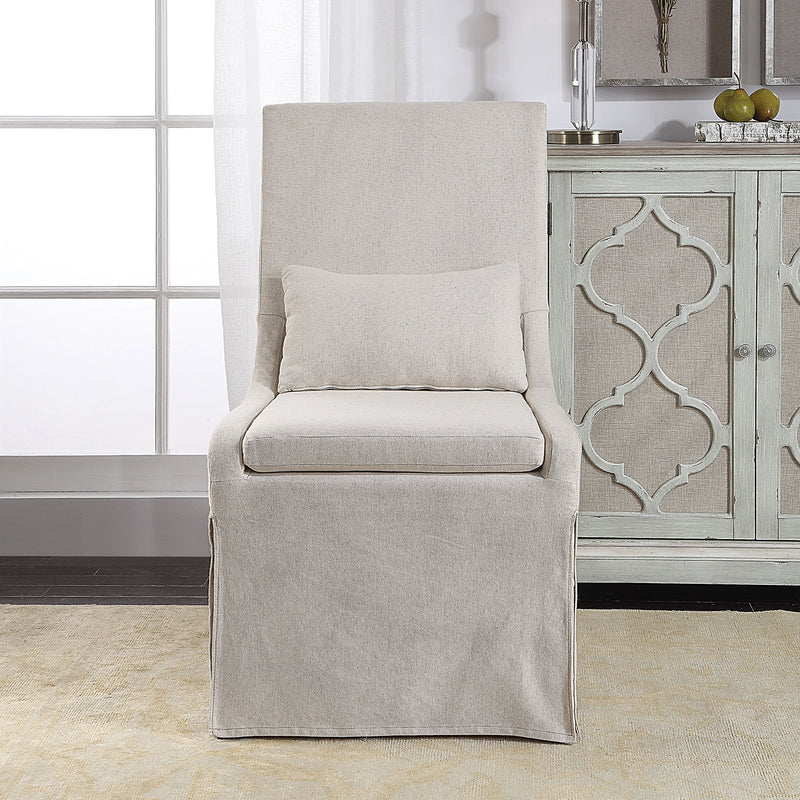 Uttermost Coley armless side chair with elegant fabric upholstery and wooden legs, modern design for dining or living space.