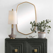 Uttermost Duronia iron wall mirror with a sleek, modern frame hanging on a neutral wall, showcasing contemporary home decor style.
