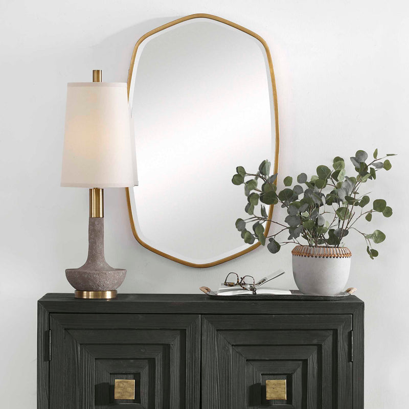 Uttermost Duronia iron wall mirror with a sleek, modern frame hanging on a neutral wall, showcasing contemporary home decor style.