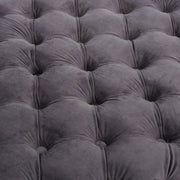 Noble House modern glam upholstered ottoman with button tufted design and plush fabric, serving as a stylish accent piece.
