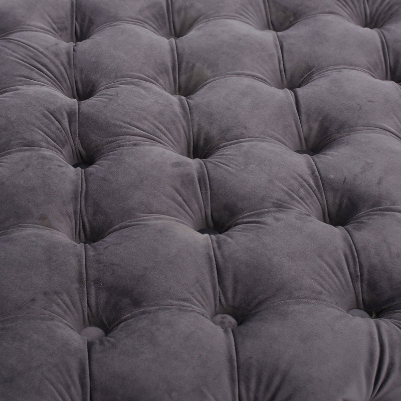 Noble House modern glam upholstered ottoman with button tufted design and plush fabric, serving as a stylish accent piece.