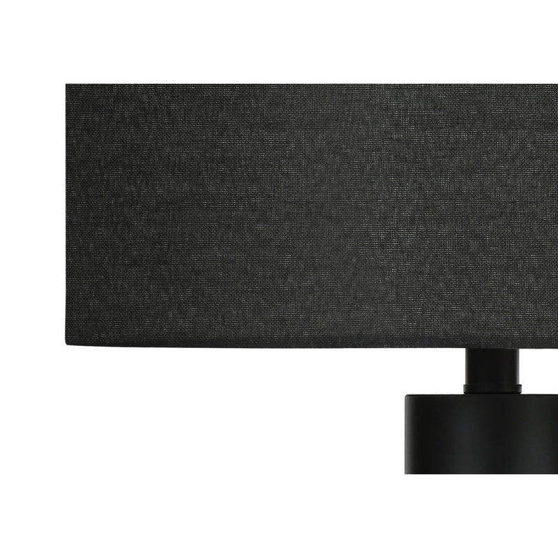 Contemporary 8th Street table lamp with a sleek, modern design and neutral-colored shade on a wooden side table.