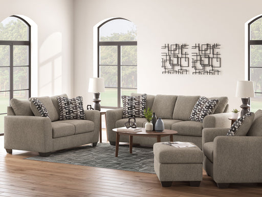 Benchcraft Triston-Peaks living room set with stationary chair and matching ottoman, showcasing plush upholstery and modern design.