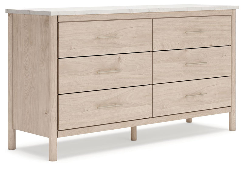 Signature Design by Ashley six-drawer dresser with sleek wood finish and modern handles, showcasing spacious storage and clean design.