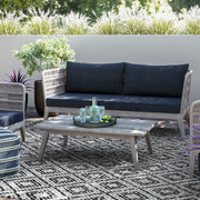 Slate gray Santiago outdoor sofa by Simpli-Home featuring cushioned seating and a sturdy frame for outdoor relaxation.