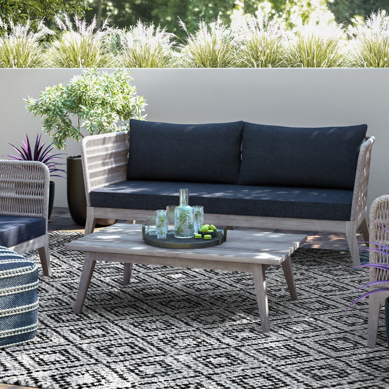 Slate gray Santiago outdoor sofa by Simpli-Home featuring cushioned seating and a sturdy frame for outdoor relaxation.