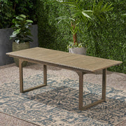 Outdoor expandable acacia wood dining table with U-shaped legs by Noble House, showing the table's surface and sturdy design.