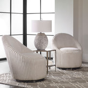 Uttermost Crue fabric swivel chair with plush upholstery and modern design, featuring a rounded back and metal base.