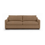 Classic Home Aspen stationary sofa with plush cushions and neutral fabric, showcasing a modern living room setup.