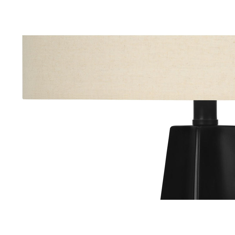 Modern black resin table lamp by 8th Street with sleek design and cylindrical shape, suitable for contemporary home decor.