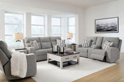 Signature Design by Ashley Biscoe reclining sofa and loveseat set featuring plush cushions and a modern design in a living room setting.