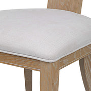 Uttermost Idris armless side chair with sleek wooden legs and a cushioned fabric seat, modern and stylish furniture design.