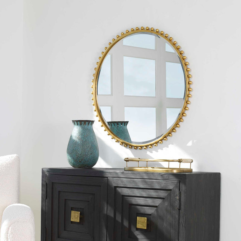 Round iron wall mirror by Uttermost featuring a sleek, modern design with a black finish and a sturdy frame.