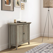 Redmond handcrafted low storage accent cabinet by Simpli-Home with a natural wood finish and simple design.