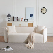 Noble House Coral curved 3-seater stationary sofa with plush upholstery and modern design, shown in a living room setting.