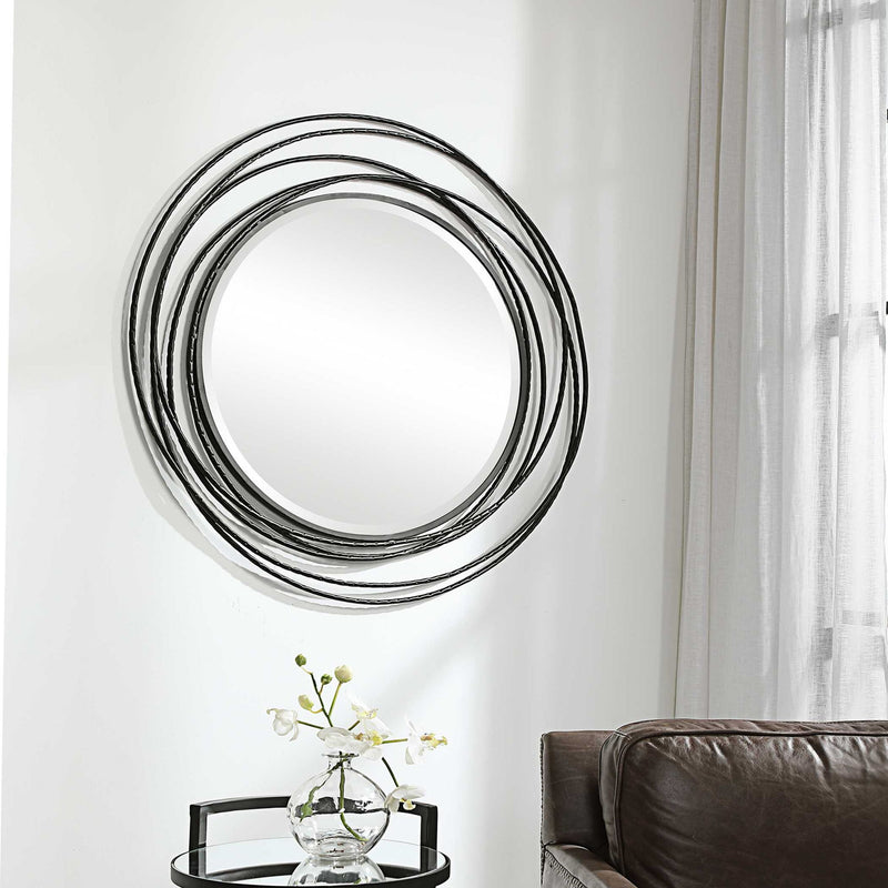 Uttermost Whirlwind round wall mirror with a sleek frame, perfect for modern interior decor.