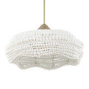 White Biddeford 5-light beaded pendant light by Uttermost hanging from a ceiling, showcasing intricate bead design and elegant lighting.