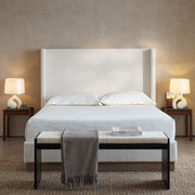 House & Home Furniture Hosford minimalist upholstered wingback bed with wood base platform, showcasing its elegant design and plush headboard.