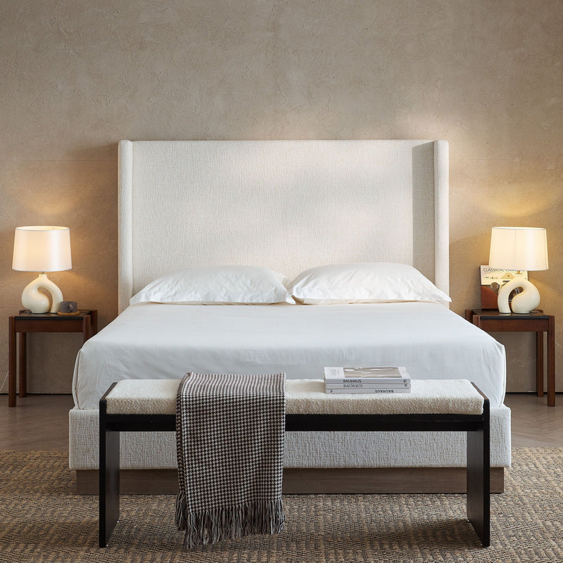 House & Home Furniture Hosford minimalist upholstered wingback bed with wood base platform, showcasing its elegant design and plush headboard.