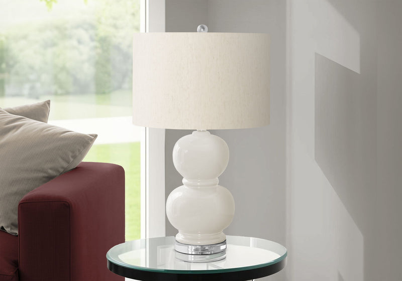Modern 8th Street contemporary table lamp with sleek design and neutral-colored shade on a wooden table.