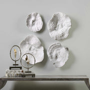 Uttermost Sea Coral wall art set of 4 in white, natural ocean-inspired wall decor with detailed coral designs.