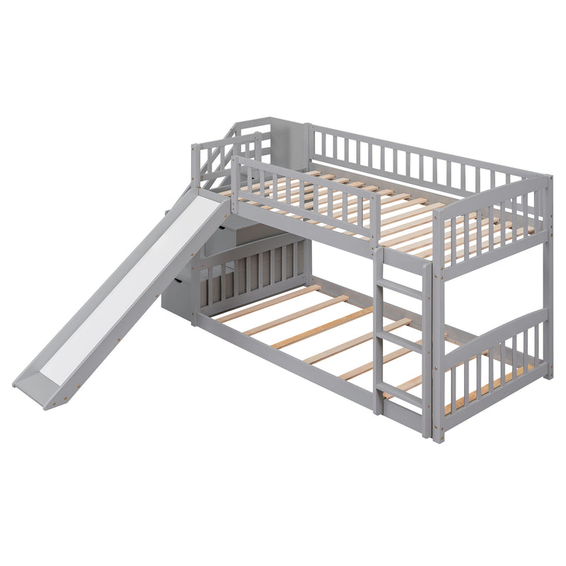 Gray DreamHaus twin over twin bunk bed with stairway, built-in slide, and two storage drawers, ideal for kids' bedrooms.