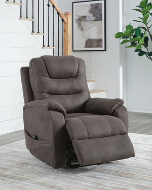 Signature Design by Ashley Snowfield Power Lift Recliner in gunmetal with padded armrests and plush cushioning.